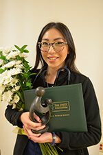 Remy Kawata holding the Daisy award