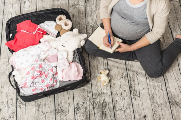 Pregnant woman packing her bag for the hospital