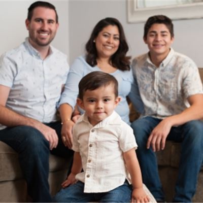 Logan Leonard standing in the front with his parents and brother in the background