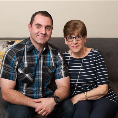 Vartan sitting on a couch with his mother