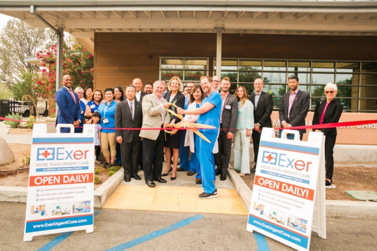 Exer Urgent Care grand opening ribbon cutting ceremony with medical staff and community members