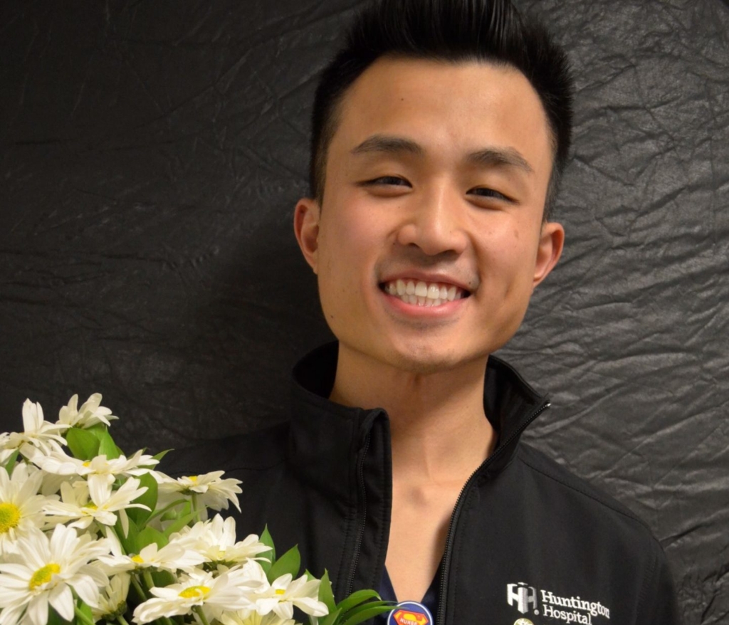 Jason Ly holding a Daisy award