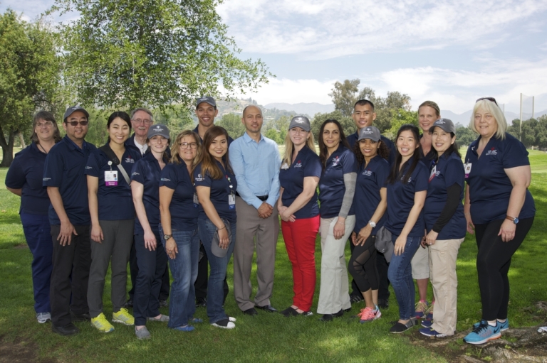 Huntington Hospital stroke team staff posing together outdoors at Saving Strokes golf event