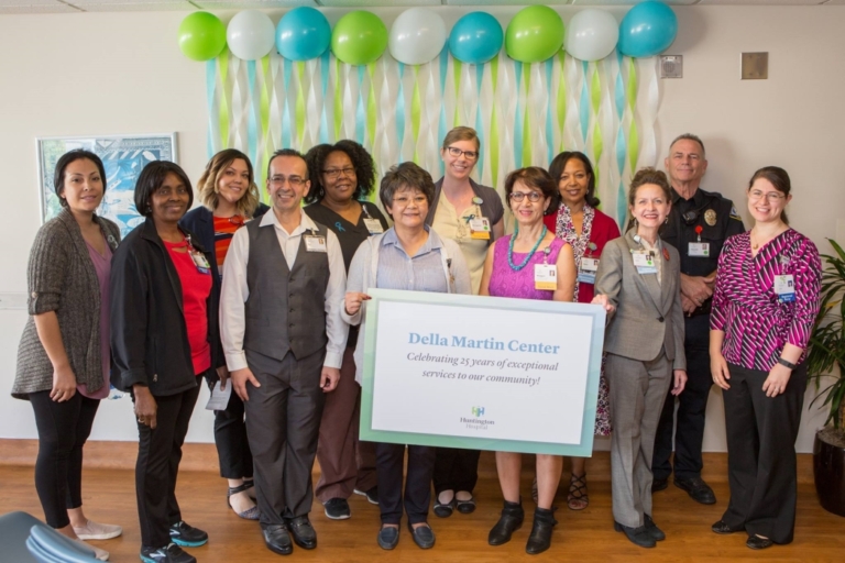 Huntington Hospital staff celebrating Della Martin Center 25th anniversary with balloons and commemorative sign