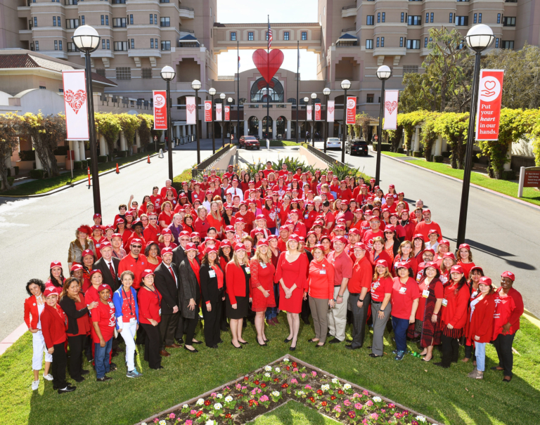 Huntington Hospital staff dressed in red gathered outside for National Wear Red Day heart health awareness