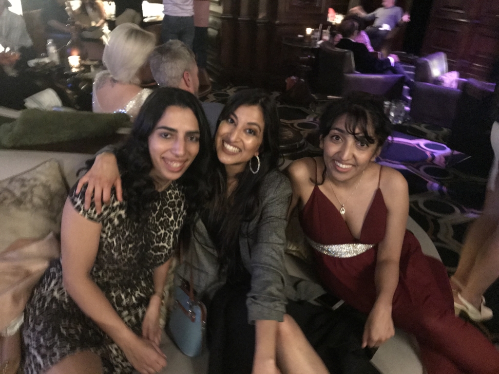 Group shot of three residents at a bar