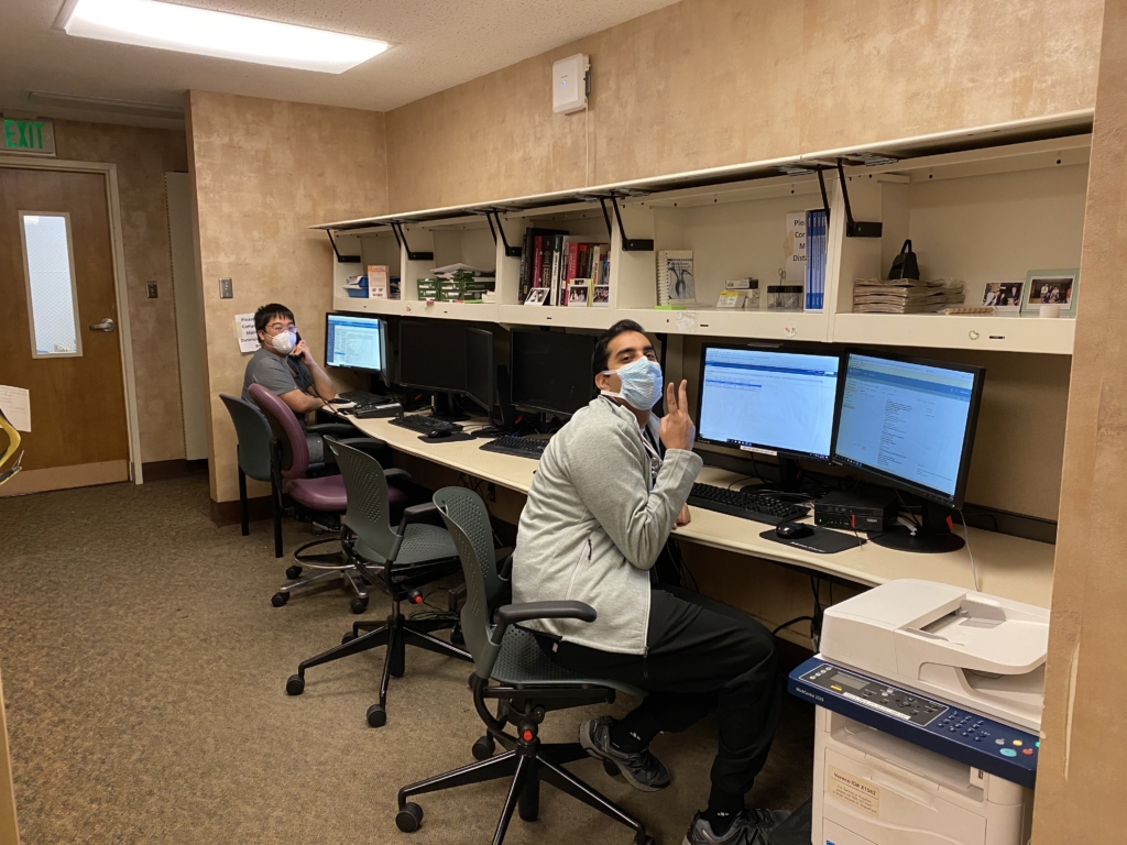 Two residents using computers posing for a photo