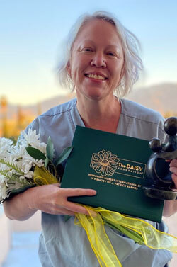 Jennifer Pai holding the Daisy award