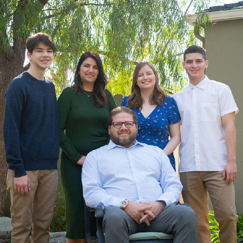 Patient stories portrait: Praslin family standing outside together