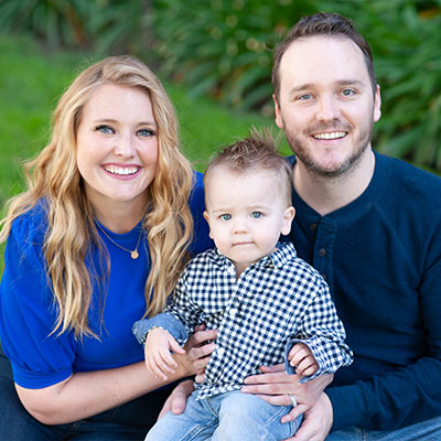 Portrait: Becky and Tyler Harman, smiling with their baby boy, Cooper.