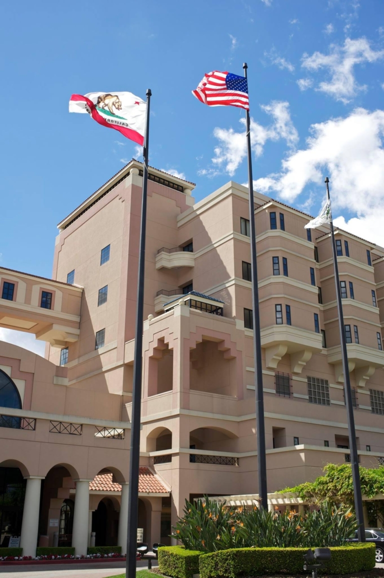 Huntington Hospital exterior with California and US flags