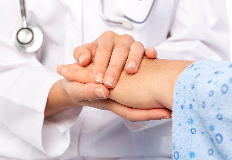 Doctor holding patient's hand with their two hands - Lung Cancer Group