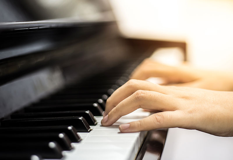 Fingers playing on piano
