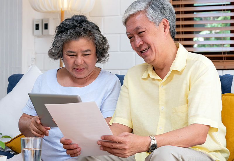 Senior asian couple looking at financial paperwork