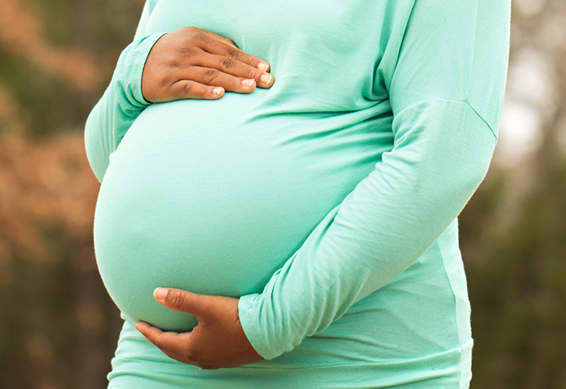 woman holding her pregnant belly