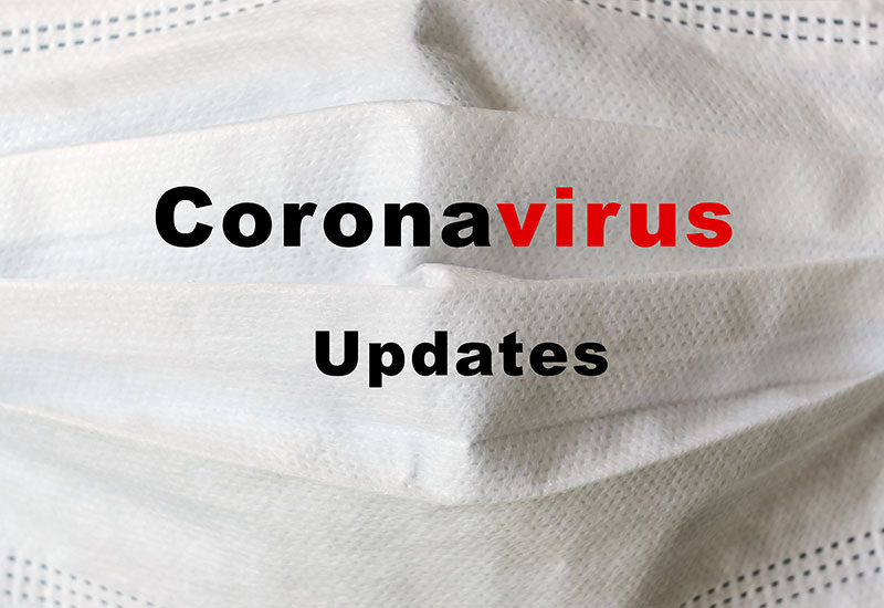 Surgical mask with the words "Coronavirus updates" written on it