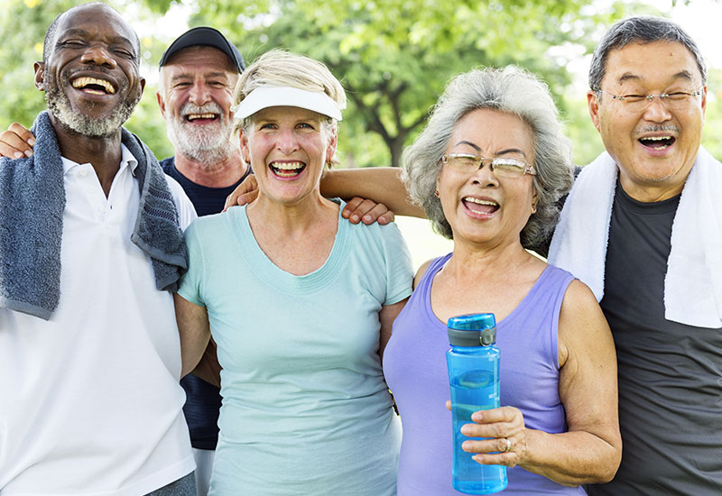 Group of five seniors in workout clothing, smiling