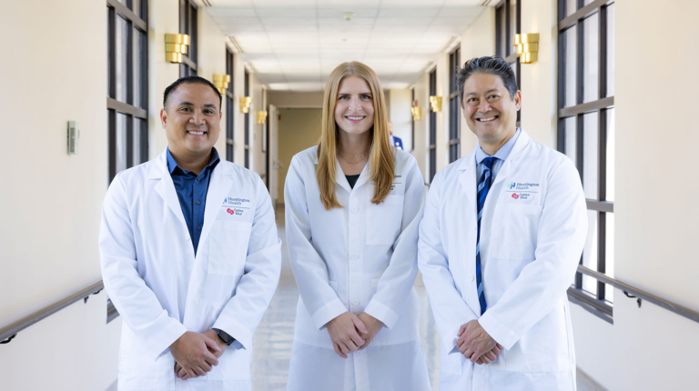 Three doctors standing in a hallway