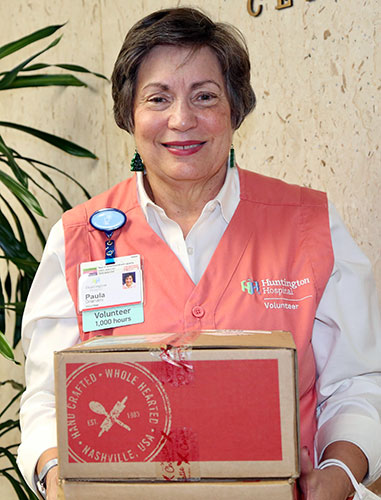 Huntington Hospital volunteer holding boxes
