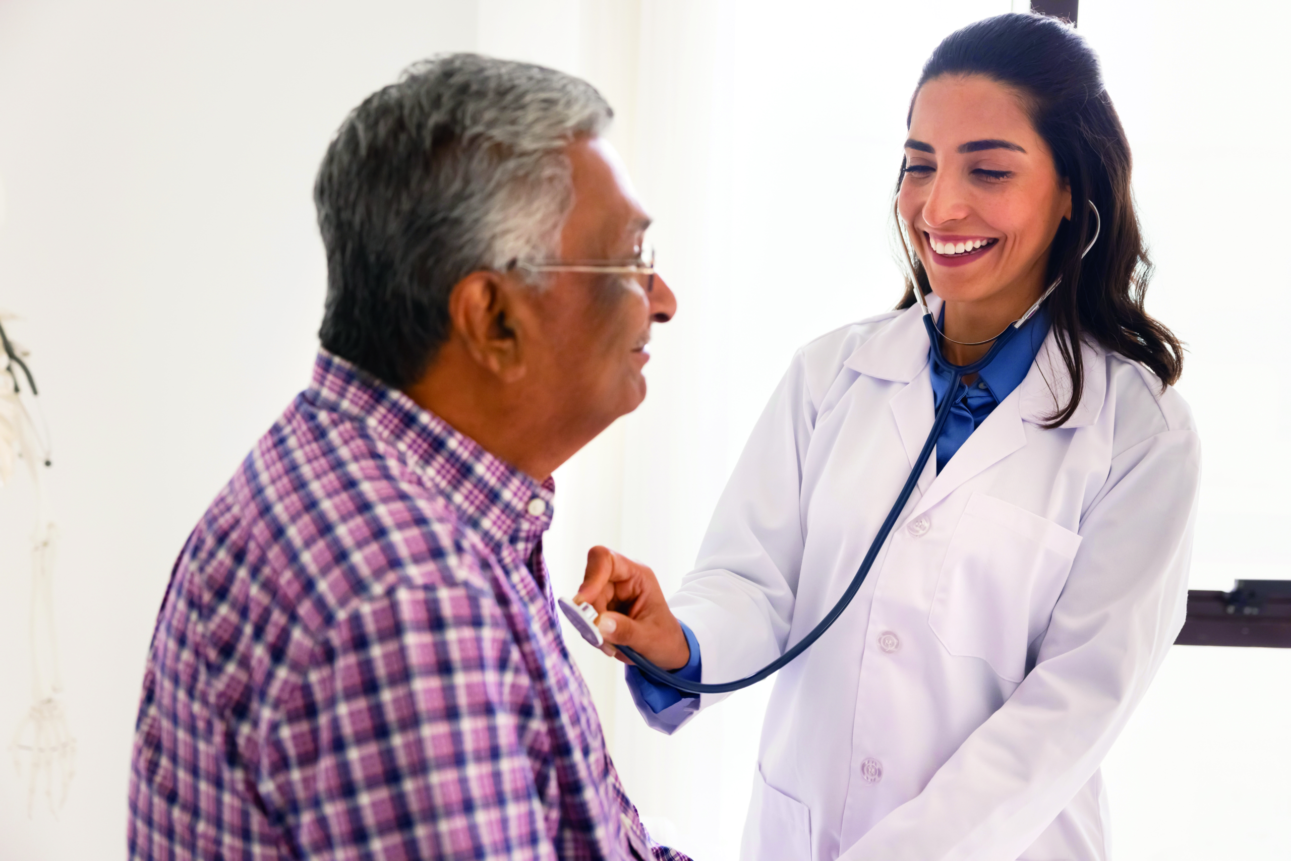 Doctor listening to patient's heart with a stethoscope