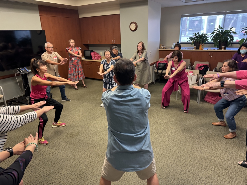 Attendees participate in the guided body movement class.