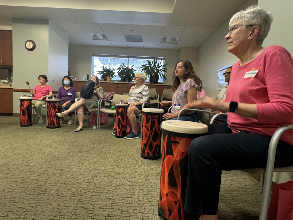 Attendees participate in the therapeutic drum circle.