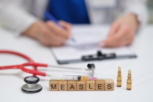 A,Doctor,Carefully,Documents,The,Measles,Vaccination,Process,,Noting,The