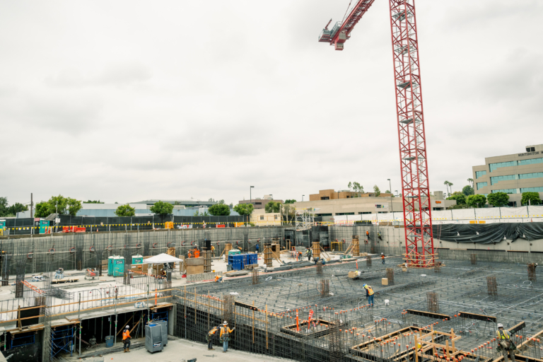picture of crane breaking ground on new part of hospital