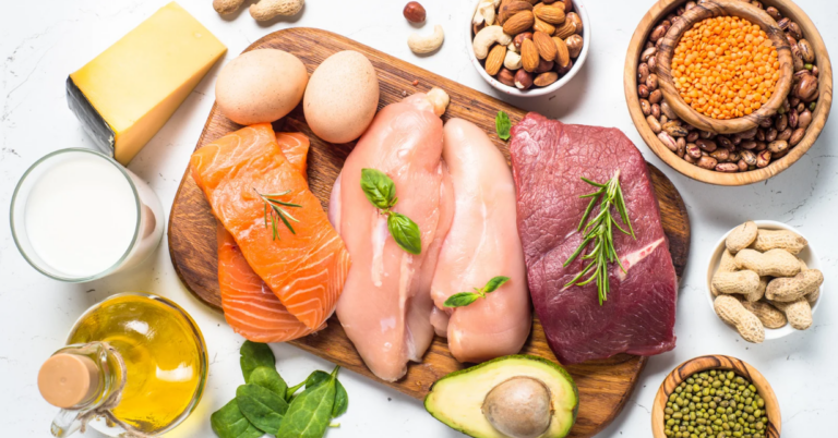 Assorted protein-rich foods including meat, fish, eggs, and nuts